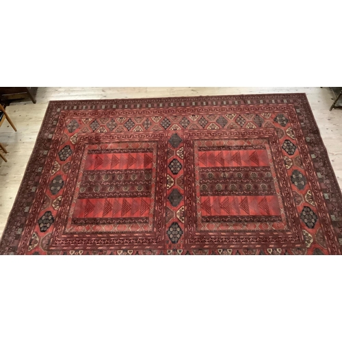 455 - A large Caucasian carpet having twin panels of geometric motifs to the centre within a broad border ... 