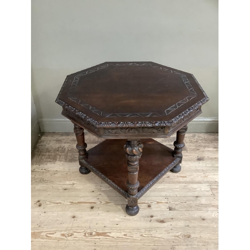 459 - A late Victorian carved oak octagonal occasional table, the rim and frieze carved with foliage and o... 