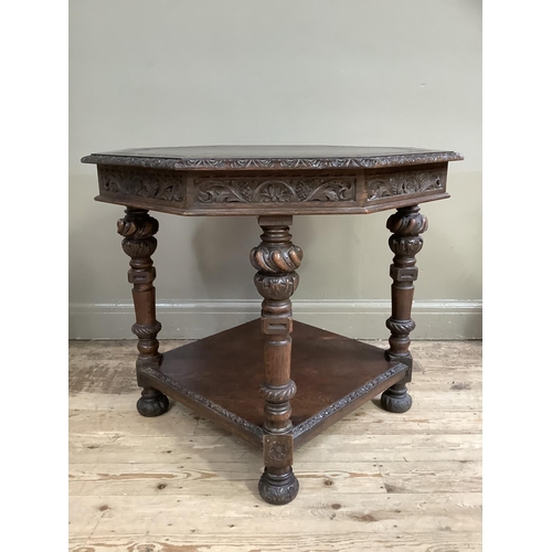 459 - A late Victorian carved oak octagonal occasional table, the rim and frieze carved with foliage and o... 