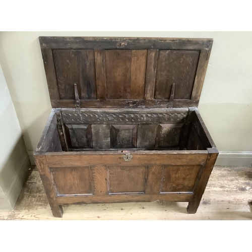 462 - A late 17th/early 18th century oak coffer, triple indented lid over conforming front on stile feet, ... 