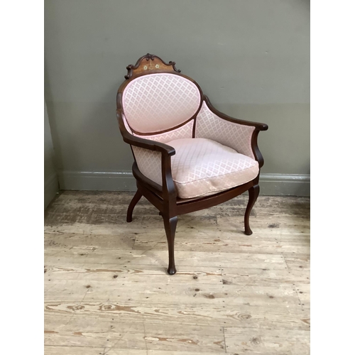 463 - An Edwardian walnut armchair having an encircling frame with arched cresting inlaid with ribboned fl... 