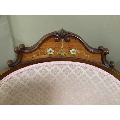 463 - An Edwardian walnut armchair having an encircling frame with arched cresting inlaid with ribboned fl... 