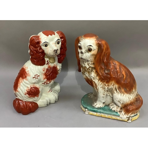 310 - An early 20th century Staffordshire spaniel dog with glass eyes, together with a reproduction spanie... 