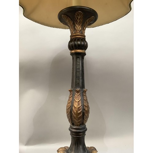 286 - A black and gilt leaf capped column table lamp on three scroll feet, with shade, 89cm high