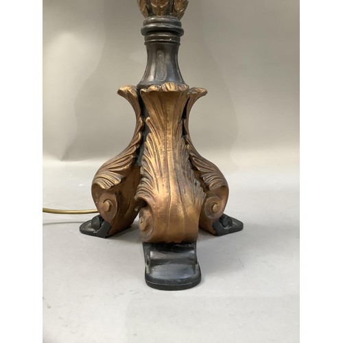 286 - A black and gilt leaf capped column table lamp on three scroll feet, with shade, 89cm high