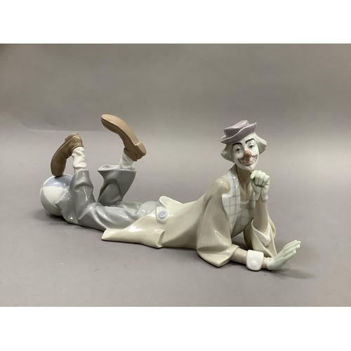 40 - A large Lladro figure of a clown reclining, his head resting on his hand, a ball at his feet, 37cm l... 