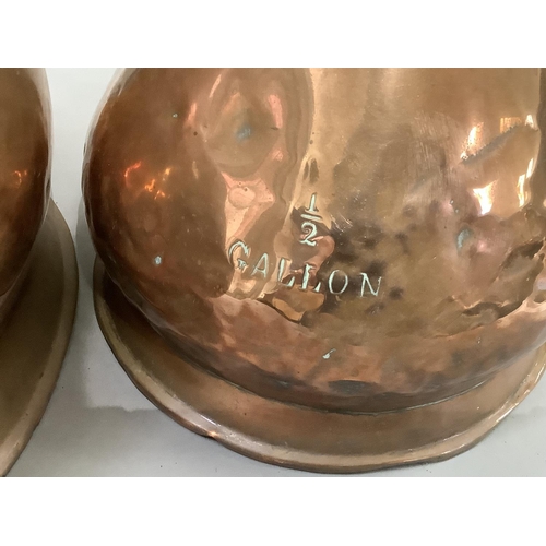 64 - A two gallon copper measure and a half gallon copper measure