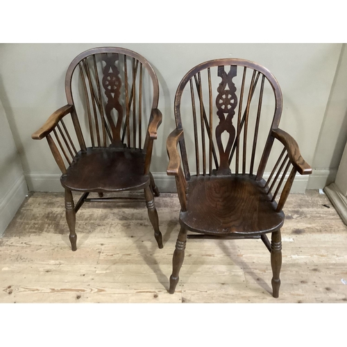 66 - A pair of dark polished beech wheel back armchairs on turned legs with H-stretchers