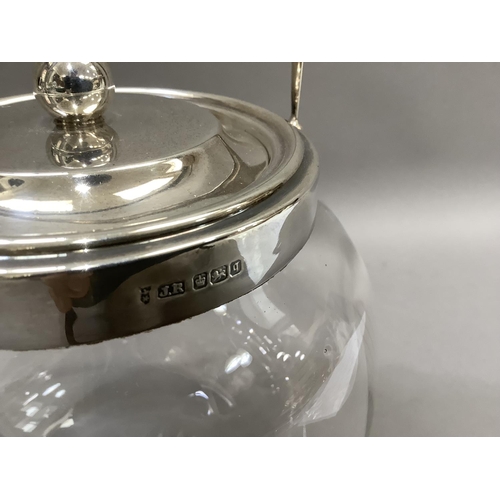 16 - A silver mounted glass biscuit barrel with star cut base, Sheffield 1908 together with a modern silv... 