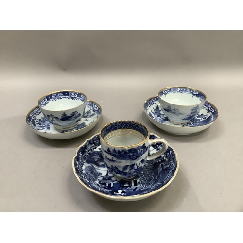 17 - A Chinese export blue and white cup and saucer painted with the willow pattern with gilt highlights ... 