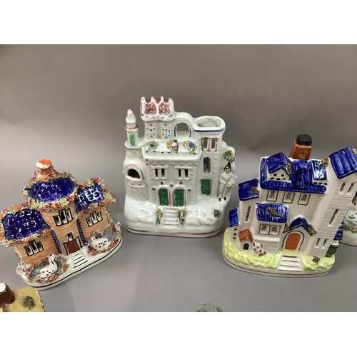 28 - A collection of early 20th century and later Staffordshire cottages, some as pastille burners