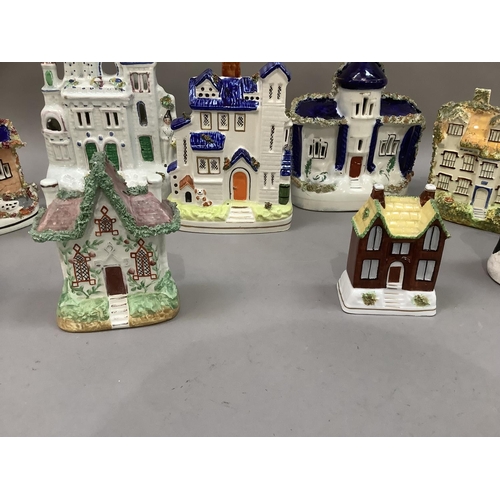 28 - A collection of early 20th century and later Staffordshire cottages, some as pastille burners