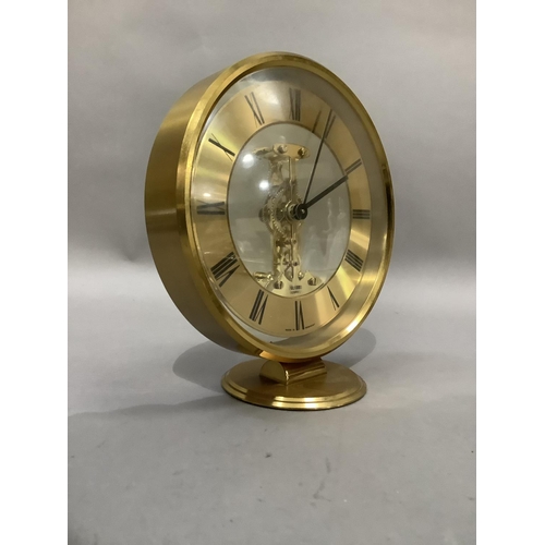 3 - An Acctim gilt metal mantel clock with exposed quartz movement, circular chaptering with black Roman... 