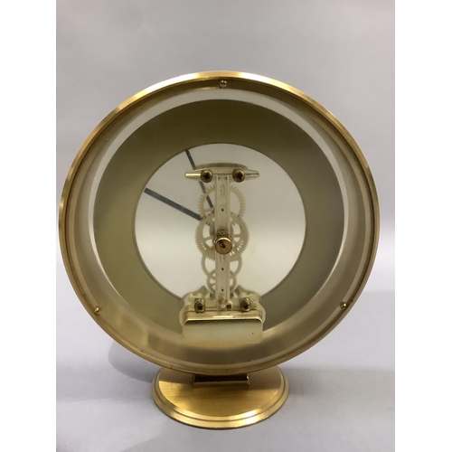 3 - An Acctim gilt metal mantel clock with exposed quartz movement, circular chaptering with black Roman... 