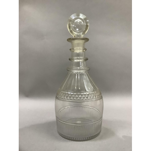 5 - A George III triple collar glass decanter, panel cut and with target stopper, 28cm high