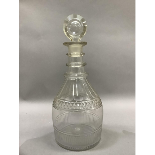 5 - A George III triple collar glass decanter, panel cut and with target stopper, 28cm high