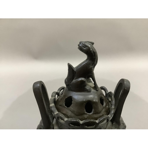 9 - A Chinese bronze two handled koro, the pierced cover with animal finial, pierced gallery to the neck... 