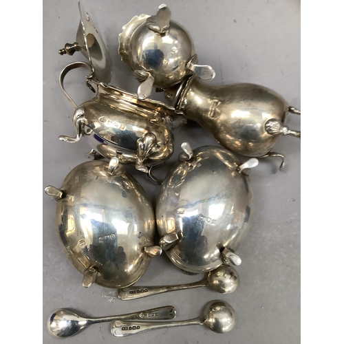 199 - A group of late 19th/early 20th century silver condiments with associated spoons and blue glass line... 