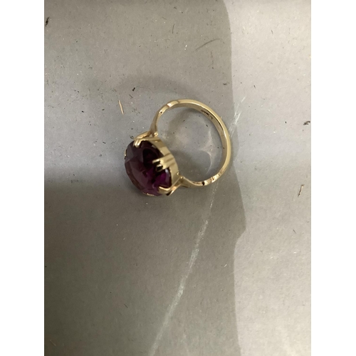 250 - A dress ring c.1950 claw set in 9ct gold with an oval faceted purple paste, approximate weight 4g