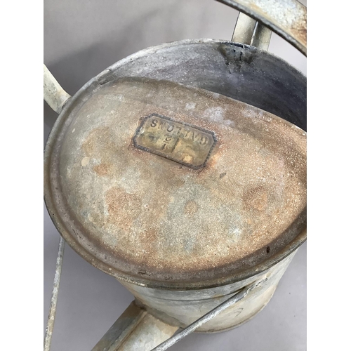 65 - A vintage aluminium watering can marked for 1 1/2 gallons together with a pair of Salter spring bala... 