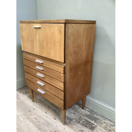 85 - A early 1970s teak cabinet having a drop front over five graduated drawers all with aluminium bar ha... 