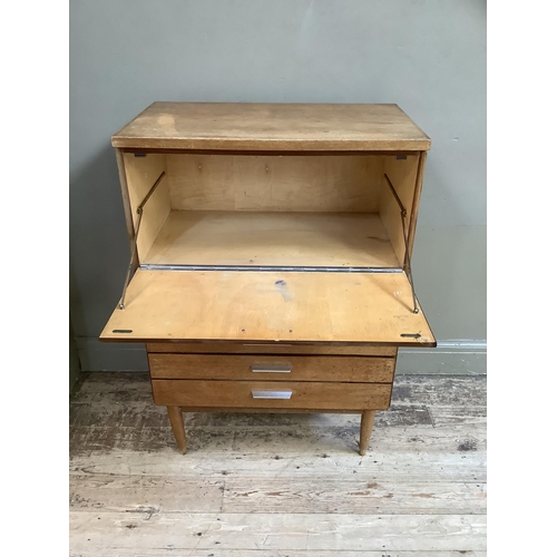 85 - A early 1970s teak cabinet having a drop front over five graduated drawers all with aluminium bar ha... 