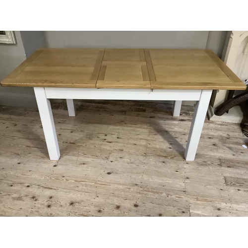 91 - An oak and grey painted extending dining table, rectangular, on square legs, 140cm long extending to... 