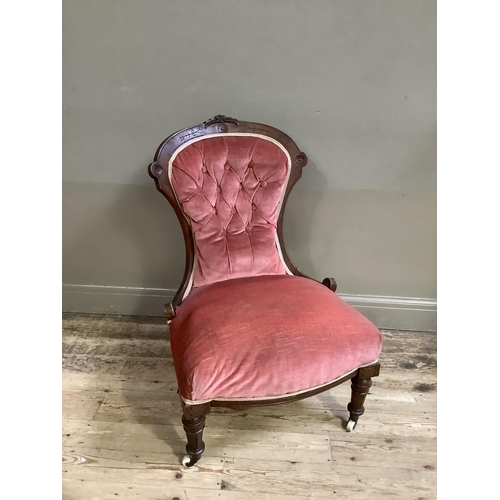 329 - A Victorian walnut chair having an encircling frame, button upholstered back and seat and on turned ... 