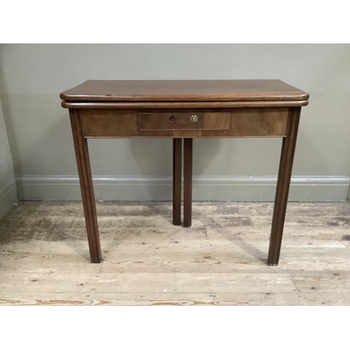 338 - A 19th century mahogany fold over tea table with small drawer to the apron and on moulded square leg... 