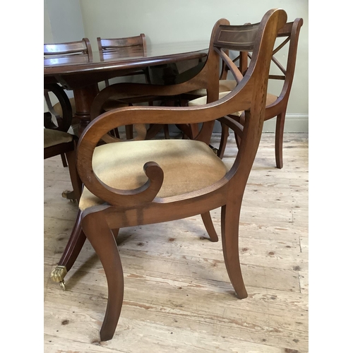 293 - A mahogany extending dining table, twin pedestal, brass paw feet and casters together with a set of ... 