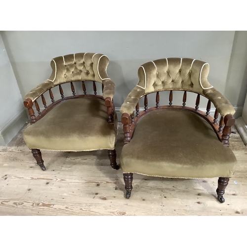 317 - A pair of Victorian mahogany tub chairs having button upholstered back above spindle frame, upholste... 