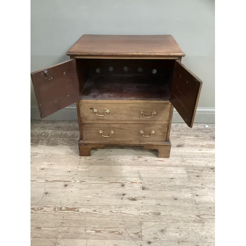 322 - A mahogany chest having two twin dummy drawer cupboard and two drawers below, with brass ring handle... 