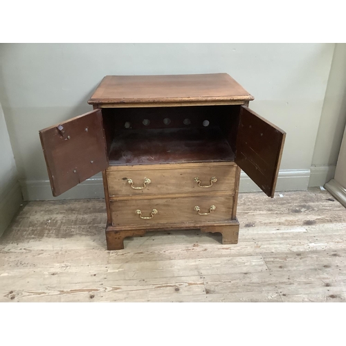 322 - A mahogany chest having two twin dummy drawer cupboard and two drawers below, with brass ring handle... 