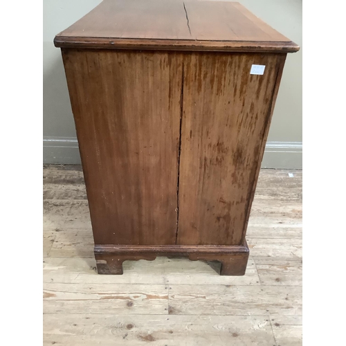 322 - A mahogany chest having two twin dummy drawer cupboard and two drawers below, with brass ring handle... 