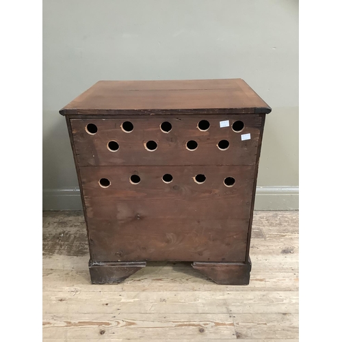 322 - A mahogany chest having two twin dummy drawer cupboard and two drawers below, with brass ring handle... 