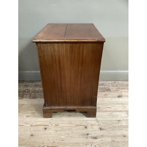 322 - A mahogany chest having two twin dummy drawer cupboard and two drawers below, with brass ring handle... 