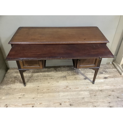 313 - An Edwardian mahogany and inlaid dressing table, the surface cross banded above a pull brushing slid... 