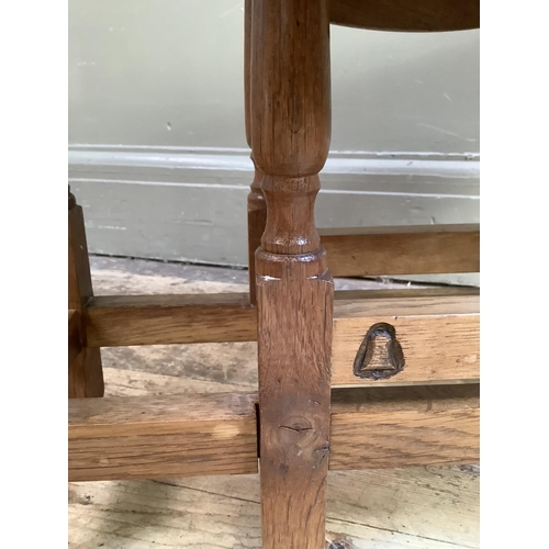 333 - A Yorkshire Carver oak gateleg occasional table having twin oval drop leaves on slender turned and s... 