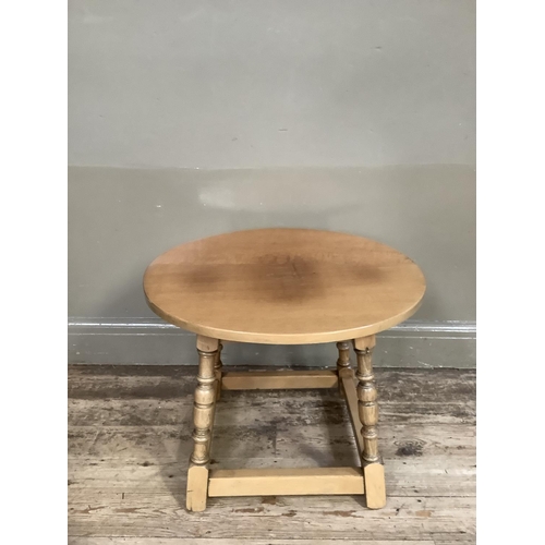 346 - An oak circular occasional table on turned and square framing, 60cm