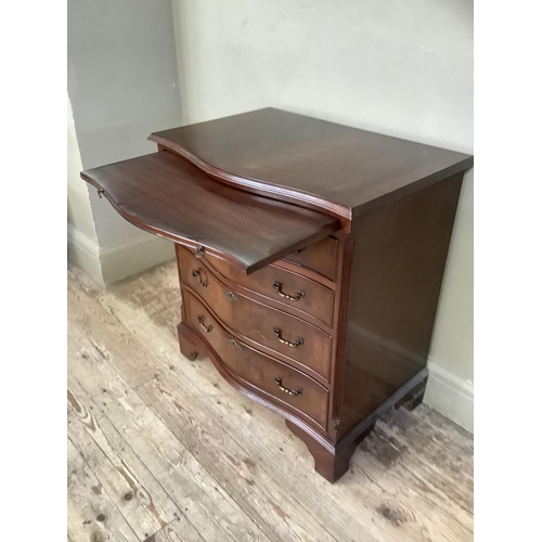 351 - A reproduction mahogany serpentine fronted chest of four long graduated drawers on bracket feet, 70c... 