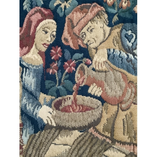 352 - A machine woven tapestry wall hanging of medieval scene together with hanging pole, 114cm wide