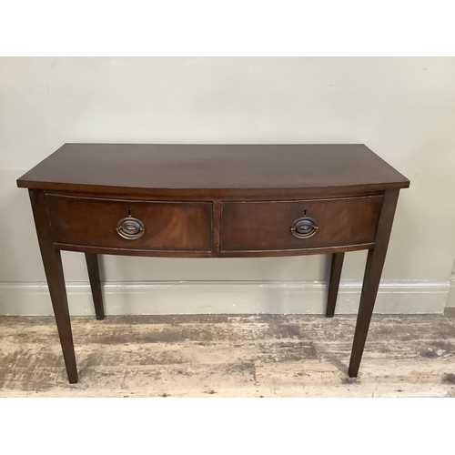 354 - A mahogany bow fronted side table with two drawers and on square legs, 105cm wide