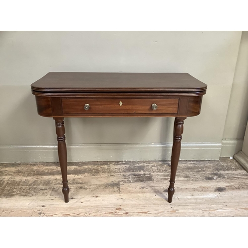 358 - A 19th century mahogany fold over card table, rectangular with rounded corners, the deep frieze with... 