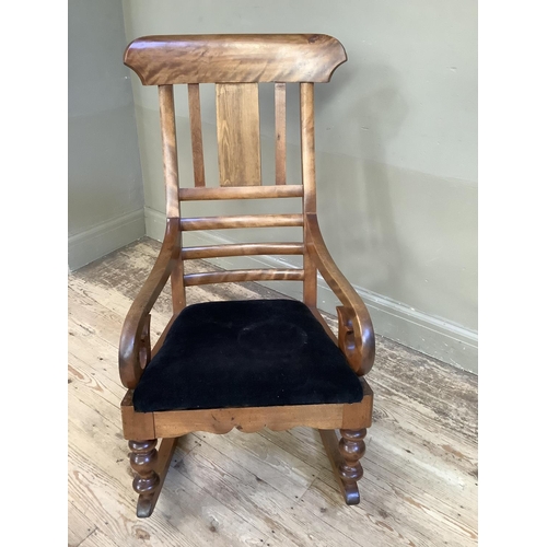 359 - A 19th century satin beech rocking chair with black upholstered seat