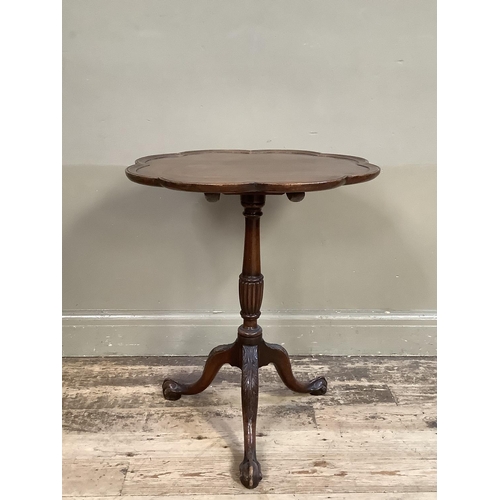 361 - A 19th century mahogany tilt top table having a scalloped top with moulded rim on a reeded and turne... 