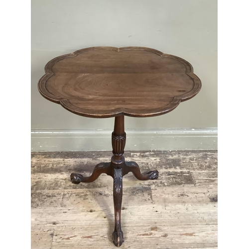 361 - A 19th century mahogany tilt top table having a scalloped top with moulded rim on a reeded and turne... 