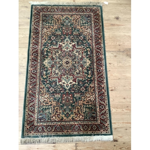 367 - A runner of Persian design in green red and camel, 140cm x 81cm