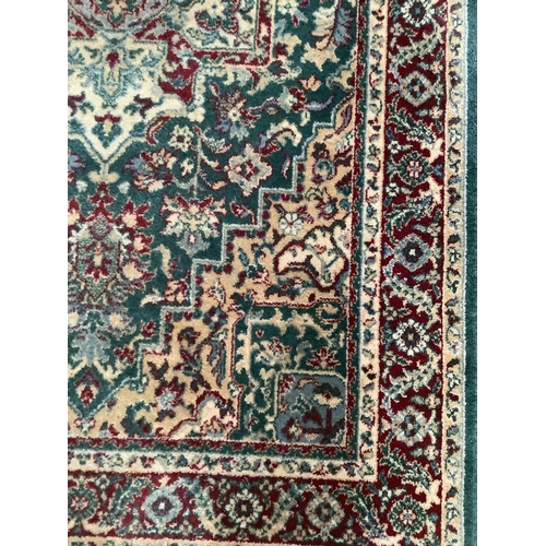 367 - A runner of Persian design in green red and camel, 140cm x 81cm