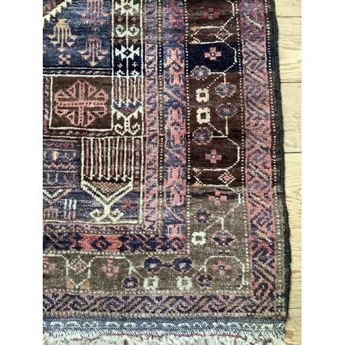 369 - A Middle Eastern rug, the blue field woven with a stylised vase of flowers within multiple borders, ... 