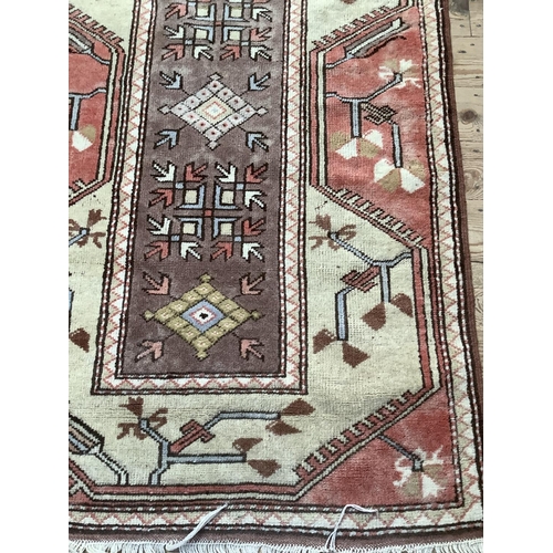 373 - A Turkish village rug hand knotted in classic colours of mushroom, ivory, salmon and brown, 140cm x ... 